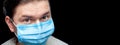 Male doctor portrait in blue medical mask.