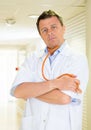 Male doctor portrait victim of Coronavirus disease COVID-19 standing in the hallway of a hospital Royalty Free Stock Photo