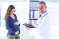 Male doctor with pregnant woman in clinic Royalty Free Stock Photo