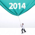 Male doctor pulls a banner of new year 2014 Royalty Free Stock Photo