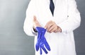 Male doctor putting blue latex medical gloves Royalty Free Stock Photo