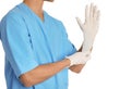 Male doctor putting on rubber gloves against white. Medical object Royalty Free Stock Photo