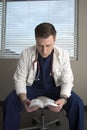 Male doctor reading his bible Royalty Free Stock Photo