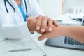 Friendly male doctor`s hands holding female patient`s hand for encouragement and empathy. Partnership, trust and medical Royalty Free Stock Photo