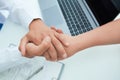 Friendly male doctor`s hands holding female patient`s hand for encouragement and empathy. Partnership, trust and medical Royalty Free Stock Photo