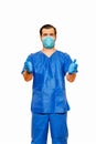 Male doctor in scrubs with protective face mask and gloves, inviting with open hands