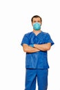 Male doctor in scrubs wearing protective face mask and gloves with cross hands waiting for patients Royalty Free Stock Photo