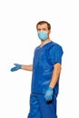 Male doctor in scrubs wearing protective face mask and gloves inviting patients for health check Royalty Free Stock Photo