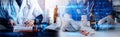 Male doctor sitting at table and writing on a document report in hospital office. Medical healthcare staff and doctor service Royalty Free Stock Photo