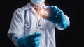 A male doctor stands holding a vaccine against coronavirus infection