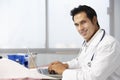Male Doctor In Surgery Using Laptop Royalty Free Stock Photo