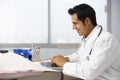 Male Doctor In Surgery Using Laptop Royalty Free Stock Photo