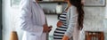 a male doctor is talking to a pregnant woman Royalty Free Stock Photo