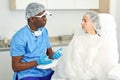 Doctor talking to a woman`s patient before being injected into the skin of face Royalty Free Stock Photo