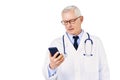 Male doctor text messaging while standing at isolated whitebackground Royalty Free Stock Photo