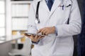 Male doctor using tablet computer in clinic, close-up. Perfect medical service in hospital. Medicine and healthcare Royalty Free Stock Photo