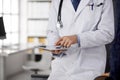 Male doctor using tablet computer in clinic, close-up. Perfect medical service in hospital. Medicine and healthcare Royalty Free Stock Photo