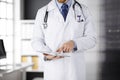 Male doctor using tablet computer in clinic, close-up. Perfect medical service in hospital. Medicine and healthcare Royalty Free Stock Photo