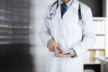 Male doctor using tablet computer in clinic, close-up. Perfect medical service in hospital. Medicine and healthcare Royalty Free Stock Photo