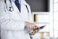 Male doctor using tablet computer in clinic, close-up. Perfect medical service in hospital. Medicine and healthcare Royalty Free Stock Photo