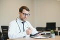 male doctor using tablet computer at his office. General practitioner using digital tablet at his clinic. Royalty Free Stock Photo