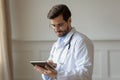 Male doctor using tablet gadget in modern hospital Royalty Free Stock Photo