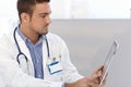 Male doctor using tablet pc