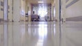 Male Doctor Walking through the Long Hallway