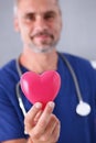 Male doctor hold in arms red heart Royalty Free Stock Photo