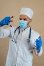 Male doctor wearing uniform mask and gloves look at blood in test tube isolated Royalty Free Stock Photo