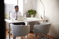 Male Doctor Wearing White Coat In Office Sitting At Desk Working On Laptop Royalty Free Stock Photo