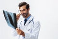 Male doctor in white coat and eyeglasses and stethoscope looking at patient X-rays for diagnosis on white isolated Royalty Free Stock Photo