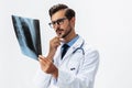 Male doctor in white coat and eyeglasses and stethoscope looking at patient X-rays for diagnosis on white isolated Royalty Free Stock Photo
