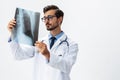 Male doctor in white coat and eyeglasses and stethoscope looking at patient X-rays for diagnosis on white isolated Royalty Free Stock Photo