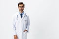 Male doctor in white coat and eyeglasses and stethoscope looking at patient X-rays for diagnosis on white isolated Royalty Free Stock Photo