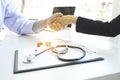 Male doctor in white coat shaking hand to female patient after s Royalty Free Stock Photo
