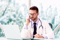 Male doctor working at desk in doctor`s office Royalty Free Stock Photo