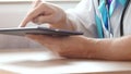Male doctor working with a modern touchscreen tablet computer Royalty Free Stock Photo