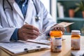 A male doctor is writing on a piece of paper, preparing a prescription for a patients medication, A medical professional Royalty Free Stock Photo