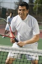 Male doubles tennis players waiting for serve