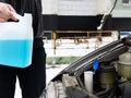 Male driver and antifreeze liquid in washer window Royalty Free Stock Photo