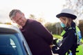 Male Driver Being Handcuffed And Arrested By Female Traffic Police Officer For Driving Offence Royalty Free Stock Photo