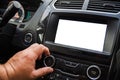 The male driver controls the settings of the car car audio system