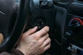 Male driver hand inserts key in ignition lock to start car Royalty Free Stock Photo