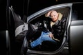 Male driver in a leather jacket in the car in the dark time. Night unusual photo shoot. Night photo shoot