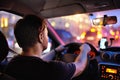 Male driver ride a car during evening traffic jam