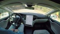 FPV: Man driving in autosteering autonomous autopilot Tesla all-electric car