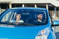 Male driving instructor and female driving school student sitting together in car smiling, learning to drive a car Royalty Free Stock Photo