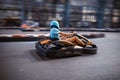 Male driving a kart on an indoor track