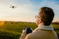 A male drone pilot flying a drone quadcopter outdoors